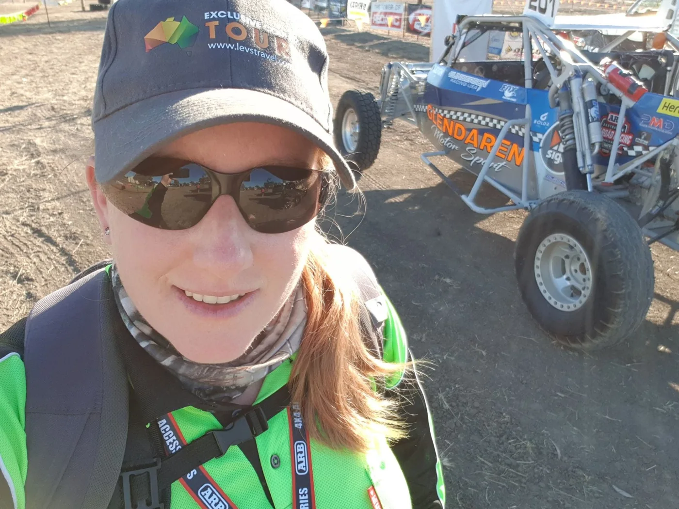 Motorsport event selfie beside an off-road racing buggy
