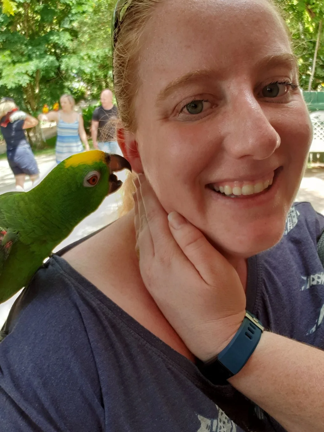 Smiling portrait with a green parrot